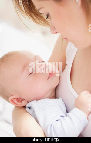 Close-up of mother carrying baby boy at home Stock Photo