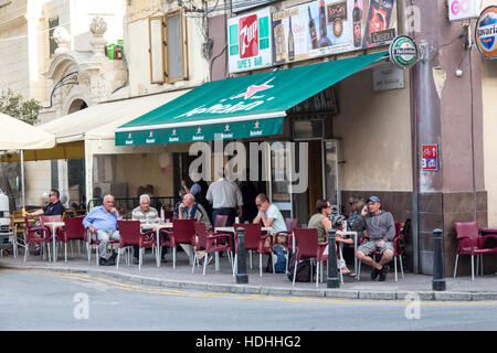 People sitting at tables in street outside bar and cafe, Victoria, Gozo Stock Photo