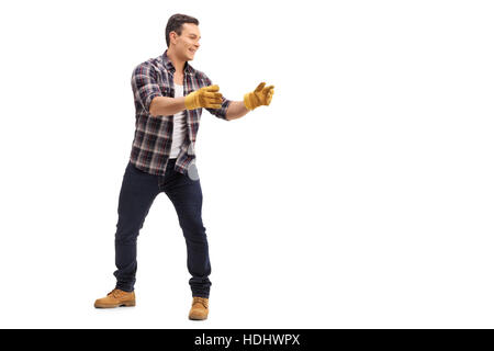 Full length portrait of a man picking up something isolated on white background Stock Photo