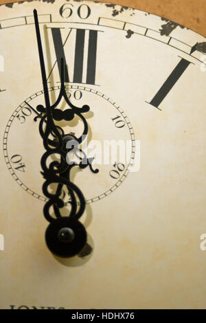 Clock face with ornate hands and time approaching twelve o'clock. Stock Photo