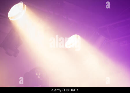 Powerful spot lights on purple background, stage illumination Stock Photo