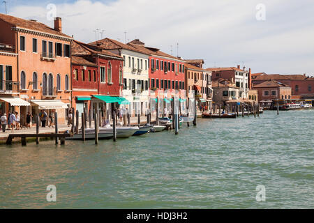 Vibrant  building facades along  tranquil canals in Murano island. Stock Photo