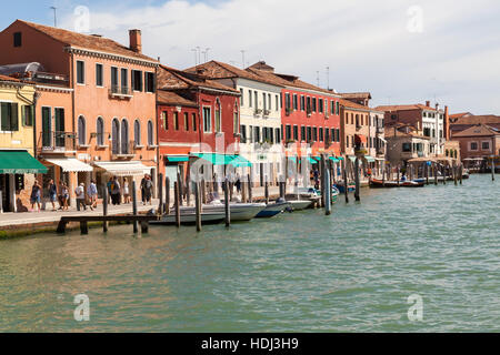 Vibrant  building facades along  tranquil canals in Murano island. Stock Photo