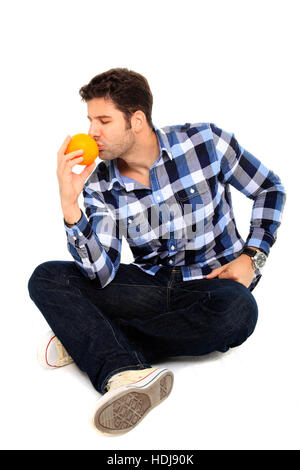 sitting man portrait smelling an orange Stock Photo