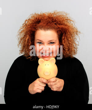 girl holding a piggy bank portrait Stock Photo - Alamy