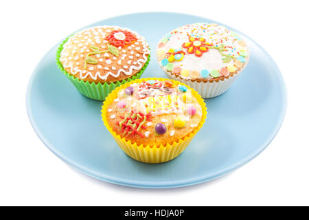 Colorful cupcakes on a blue plate isolated over white Stock Photo