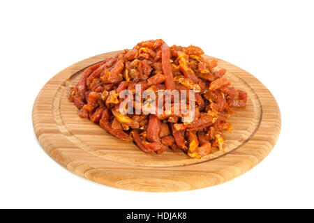 A pile of fresh raw meat on a wooden plate isolated over white Stock Photo