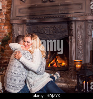 Man and a woman in warm knitted sweaters, hugging Stock Photo