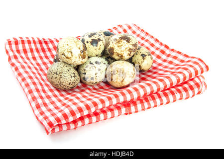 Quail eggs on a red white checked napkin isolated over white Stock Photo