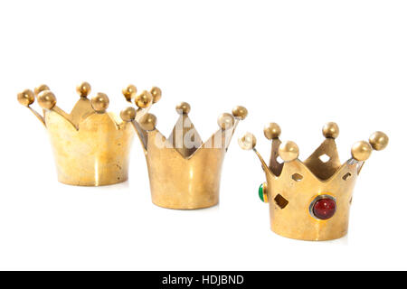 Three golden crowns in a row isolated over white Stock Photo