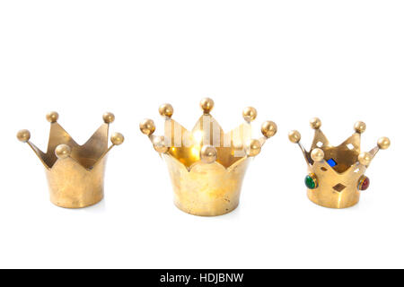 Three golden crowns in a row isolated over white Stock Photo