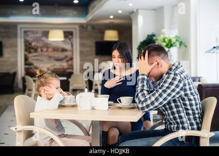 Little girl doesn't want to hear arguing of parents Stock Photo