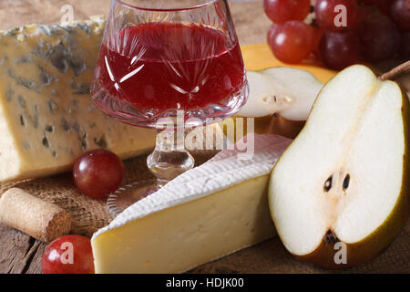 Red wine with cheese and fruit close-up on the table. horizontal Stock Photo