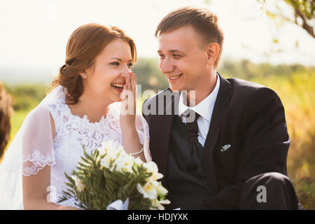portrait of a couple bride and groom on the background of field. Stock Photo