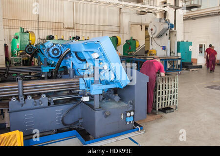 metal laser cutting machine operator working in factory. Stock Photo