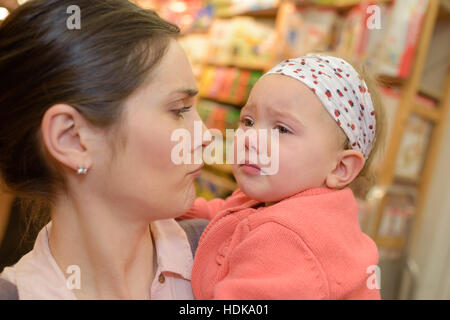 mother comforting her crying little girl Stock Photo