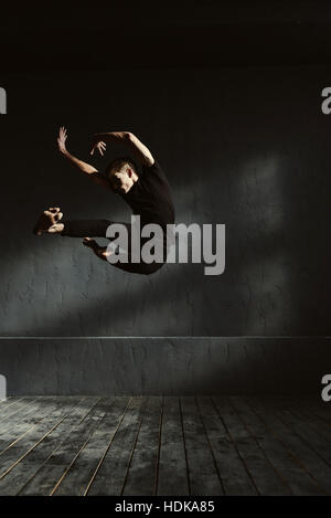 Flexible young dancer performing in the air Stock Photo