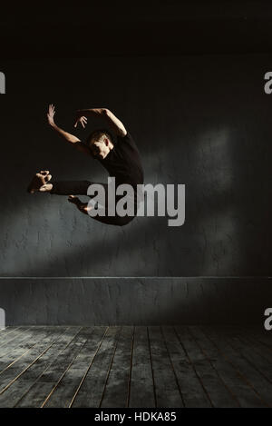 Flexible young dancer performing in the air Stock Photo