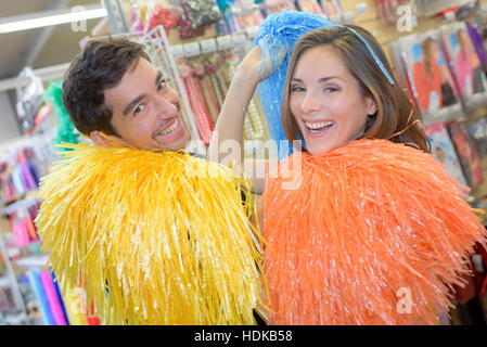 Man and woman with colorful pompoms Stock Photo