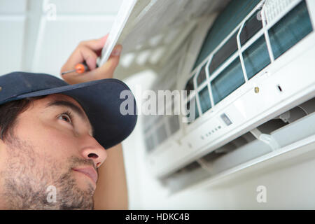 Man inspecting air conditioning unit Stock Photo