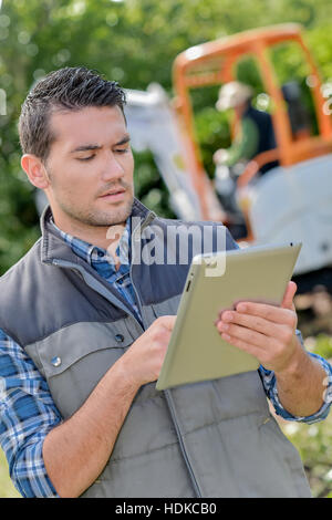 Foremen using a tablet on site Stock Photo