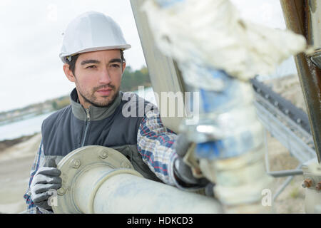 pipe fitter checking the connections Stock Photo