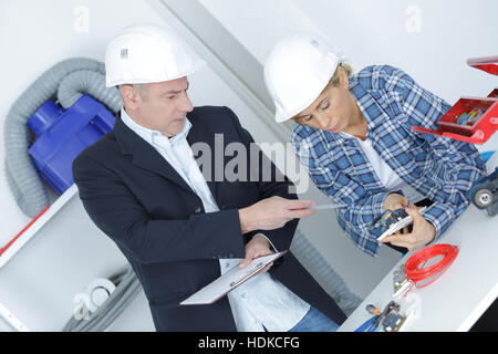 two young architects discuss about construction plan Stock Photo