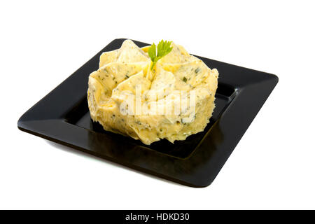 Garlic butter on a black plate isolated over white Stock Photo