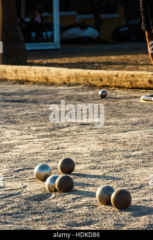 Petanque ball boules bowls on a dust floor, photo in impact. Game