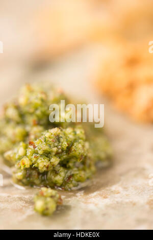 Green pesto sauce in extreme close up. Made of fresh basil. Traditional italian cuisine. Stock Photo