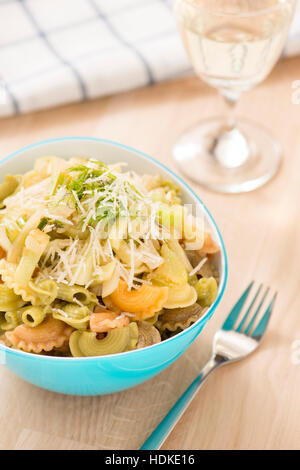 Pasta with fennel and onion in lemon dressing. Vegetarian food served with white wine. Healthy eating. Stock Photo