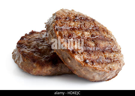 Two grilled hamburger patties isolated on white. Stock Photo