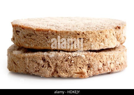 Two frozen hamburger patties isolated on white. Stock Photo