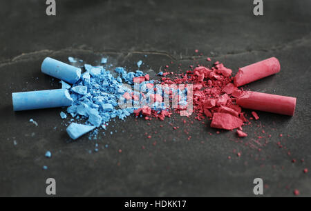 Blue chalk and pink chalk crumbled and blending together. Stock Photo