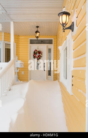 A front entrance door with snow drifts after a blizzard in Winkler, Manitoba, Canada. Stock Photo