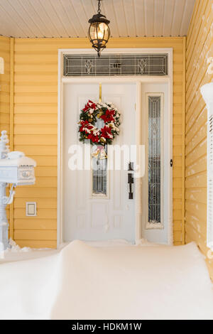 A front entrance door with snow drifts after a blizzard in Winkler, Manitoba, Canada. Stock Photo