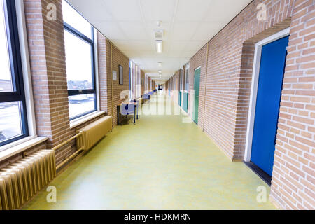 Long straight and empty corridor in secondary school building Stock Photo