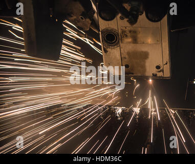 Industrial Laser cutting processing manufacture technology of flat sheet metal steel material with sparks laser cut metal splashes Stock Photo