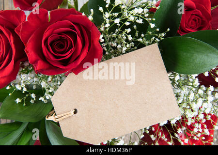 Red roses and baby's breath and gift tag with copy space Stock Photo