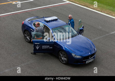 A Maserati  Safety Car and its drivers on the grid at Silverstone before the start of the FIA Masters Historic Formula One race Stock Photo