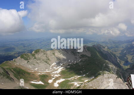 The beautiful view from Switzerland's Säntis Mountain on a cloudy day in the Swiss Alps. Stock Photo