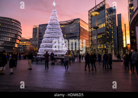 London City Hall at a beautiful pink evening sky with Christmas tree in the foreground. Stock Photo