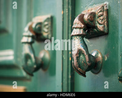 Old hand shaped metal door handles in Bairro Alto, Lisbon, Portugal Stock Photo