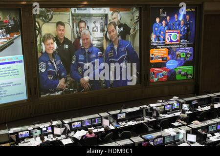 Technicians at the Russian Mission Control Center watch the front screens as NASA Expedition 50 prime crew members American astronaut Peggy Whitson, Russian cosmonaut Oleg Novitskiy of Roscosmos, and French astronaut Thomas Pesquet of the European Space Agency arrive at the International Space Station after docking the Soyuz MS-03 spacecraft November 20, 2016 in Korolev, Russia. Stock Photo