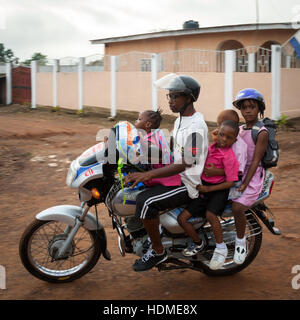Okada (motorcycletaxi in Sierra Leone) carrying four passengers. In Europe you take a car for this Stock Photo