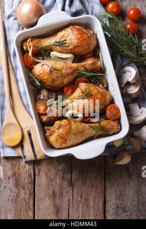 chicken legs in a baking dish and ingredients. vertical top view Stock Photo