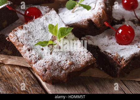 brownie cake with mint and cherry macro on paper. horizontal Stock Photo