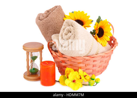 Spa set with towels, sandglass, candle and flowers isolated on white background. Stock Photo