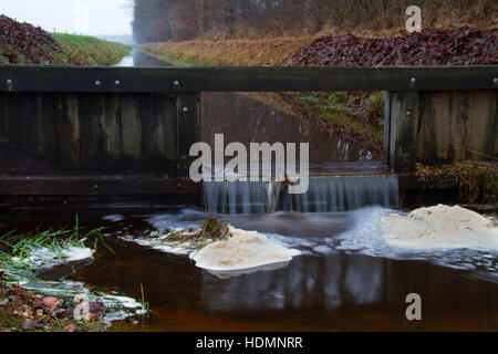 Wooden dam in canal, controlling the water level Stock Photo