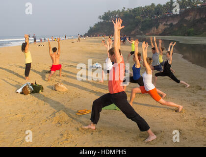 Beach Yoga  at sunrise in Varkala, Kerala, India Stock Photo